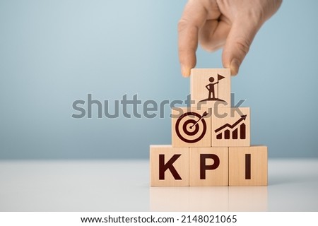 KPI - Key Performance Indicator. Businessman holds cube with KPI icon, KPI key performance indicator increase optimisation business. Business planning and measure success, target achievement. Royalty-Free Stock Photo #2148021065