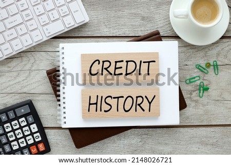 Credit History. wooden blocks on a notepad on a light table. text on wooden blocks