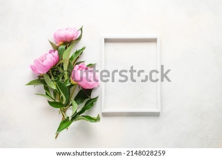 Pink peony Flowers in a frame on a bright background. Top view. Flat lay