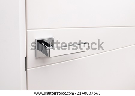 Door handles elements close up. Door handle on white closed doors in modern loft style in interior. Concept of accessories for interior design home interior of apartment or office. Royalty-Free Stock Photo #2148037665