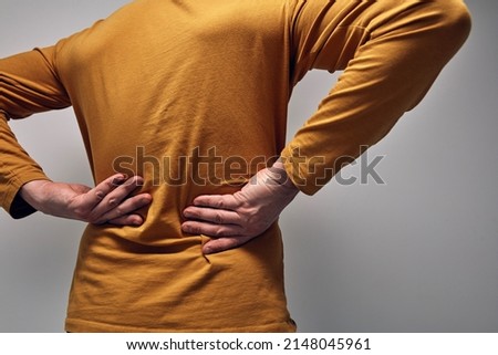Adult caucasian man with back pain.