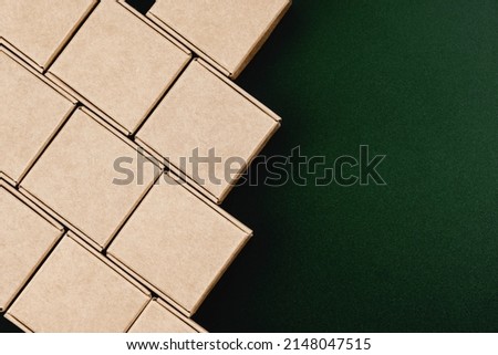 Neat rows of cardboard boxes on green background with space for text Royalty-Free Stock Photo #2148047515