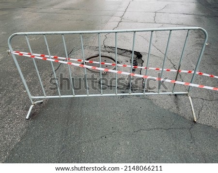failure on the road fenced with a special tape. Danger road failure tape fencing