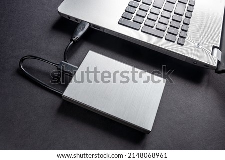 The hard drive is connected to the computer via a cable. Backup. Secret information.