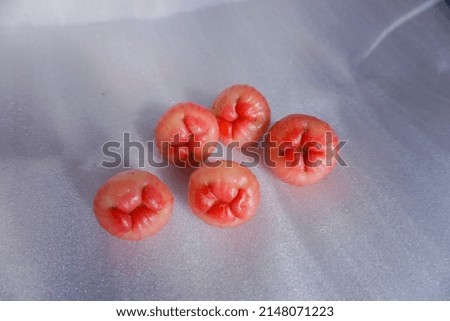 concept photo of water guava fruit on a white background