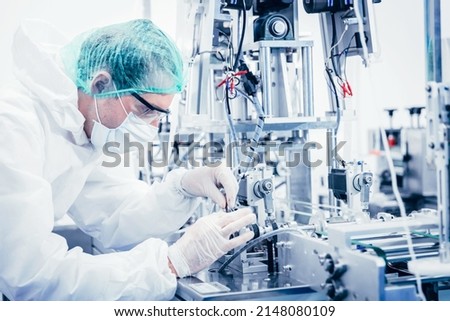 Science worker engineer service fix repair advance machine in medical equipment hygine factory. Royalty-Free Stock Photo #2148080109