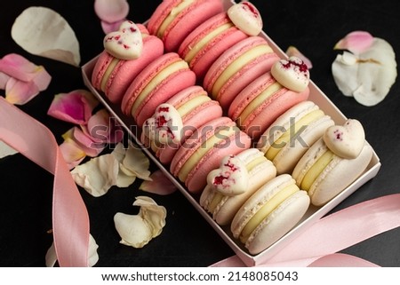 French macarons. Beautiful macaroons with heart decoration. Stylish arrangement sweet. Flat lay, top view. Macro photo