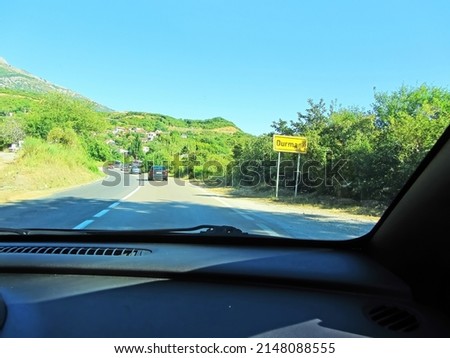 Directional sign pointing. A road sign at the entrance to a European village. Yellow sign on the road. A road in a mountain town image