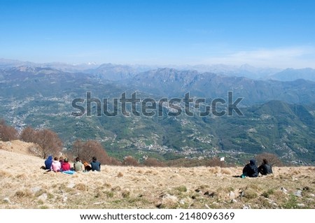 Hikers Relaxing on Monte Linzone Peak. Italy