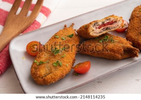 Anchovies stuffed with peppers and cheese, battered and fried. Traditional tapas from the south of Spain.
