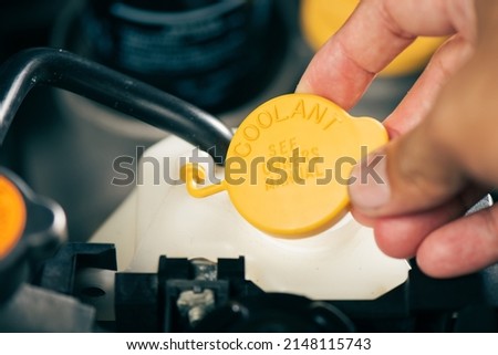 Car's coolant system, close up coolant container in engine room. Royalty-Free Stock Photo #2148115743