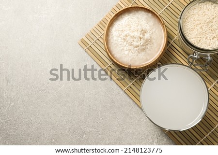 Flat lay composition with rice water on light grey table. Space for text Royalty-Free Stock Photo #2148123775