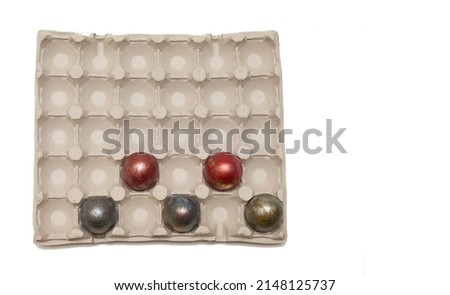 Festive Easter eggs, painted in dark red paint, are staggered in a special cardboard box for safe transportation and storage. Studio photography on a large banner - top view.