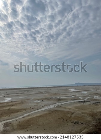 View of Mount Bogdo and salty water beach from the sandy beach of the salt lake Baskunchak in the Astrakhan region