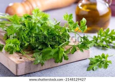Fresh italian parsley on the table. Green parsley. Royalty-Free Stock Photo #2148129427