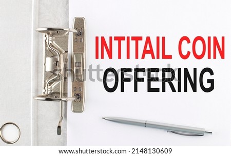 INITIAL COIN OFFERING text on paper folder with pen. Business concept