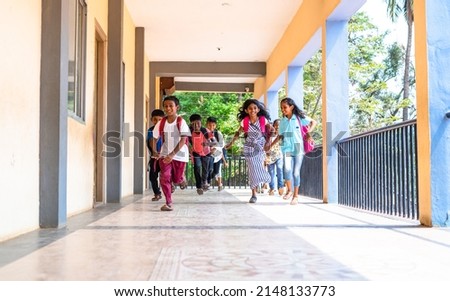Enjoying group of kids running at school corridor for going to classroom - concept of education, reopen school, active childhood and learning. Royalty-Free Stock Photo #2148133773