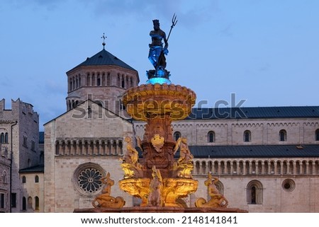 Illuminated Fountain of Neptune in the colors of the Ukrainian flag in front of Trento Cathedral in the Square Piazza Duomo in Trento, Italy Royalty-Free Stock Photo #2148141841