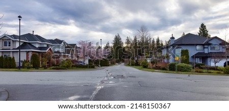 Fraser Heights, Surrey, Greater Vancouver, BC, Canada. Street view in the Residential Neighborhood during a colorful spring season. Colorful Sunrise Sky. Royalty-Free Stock Photo #2148150367