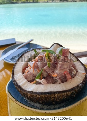 Delicious fresh poisson cru served in coconut, row tuna marinated in coconut milk and lime juice, traditional dish of Tahiti, Bora Bora, French Polynesia Royalty-Free Stock Photo #2148200641