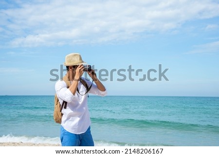 Happy lifestyle asian man in sea beach, relax on the beach in summer. Travel Concept
