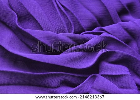 Background texture: purple silk fabric. Elegant lavender tissue, lilac dress textile with folds. Delicate chiffon clothing, 3d abstract violet waves. Very peri 