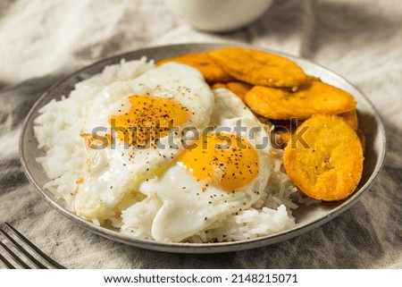 Homemade Cuban Arroz con Huevos with Fried Plantains for Breakfast Royalty-Free Stock Photo #2148215071