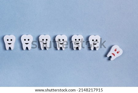 Tooth loss. Teeth row with fallen baby milk or adult one on blue background. Cavity, poor oral hygiene, gums inflammation, trauma. High quality photo Royalty-Free Stock Photo #2148217915