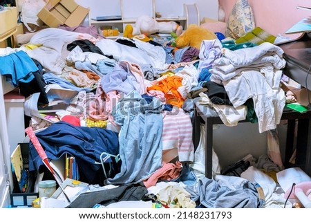 A room cluttered with piles of clothes Royalty-Free Stock Photo #2148231793