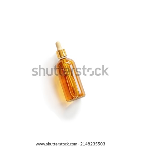 Serum or liquid collagen dropper bottle isolated on white background with sunlight and shadow with caustic effect. Anti age cosmetics products. Skincare beauty product, summer concept. Above view Royalty-Free Stock Photo #2148235503