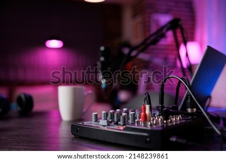No people at empty desk with podcast equipment in living room, recording sound for social media channel production. Nobody in live broadcasting space with technology. Close up. Royalty-Free Stock Photo #2148239861