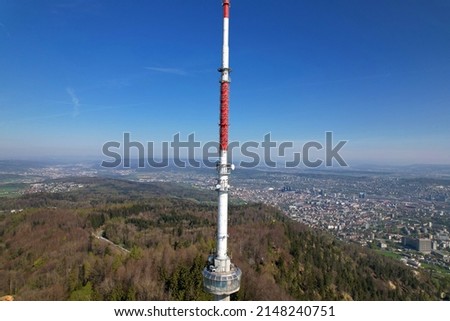Aerial view over City of Zürich with communications tower in the foreground on a beautiful spring day with blue cloudy sky background. Photo taken April 21st, 2022, Zurich, Switzerland.