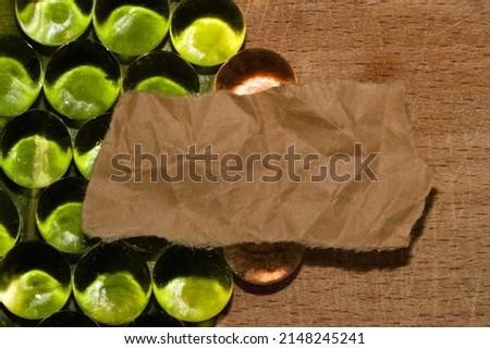 left half green abstract background with beads that reflect the green color of durga leaves half vintage wooden background, in the middle of the vitnage crumpled paper as copy space, eco design