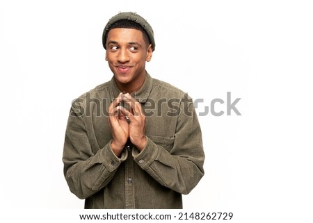 Sneaky man gesticulating with fingers planning devious tricks and cheats, scheming prank, having fun. Indoor studio shot isolated on white background Royalty-Free Stock Photo #2148262729