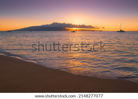 a shot of sunset over island of lanai from kaanapali beach Royalty-Free Stock Photo #2148277077