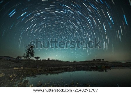 Circular star trails over the lake. Astro photography and Nightscape photography at Mandan Lake, Rajpipla, Gujarat Royalty-Free Stock Photo #2148291709