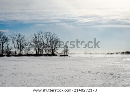 cold winter day by the St. Lawrence river Royalty-Free Stock Photo #2148292173