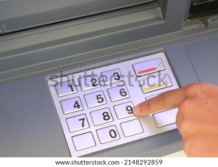 forefinger of hand typing secret pin into numeric keypad Royalty-Free Stock Photo #2148292859