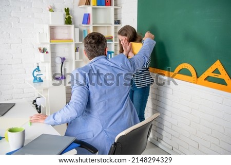 angry teacher shouting at child at blackboard Royalty-Free Stock Photo #2148294329