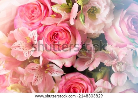 Festive bouquet of roses and alstroemerias for wedding and birthday with cold warm toning.