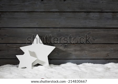 Star shaped christmas decoration on pile of snow against wooden wall Royalty-Free Stock Photo #214830667
