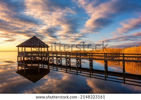 Calm water, sunset reflections, and gazebo along the Currituck Sound in North Carolina's Outer Banks