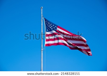 American flag waving in blue sky july national united