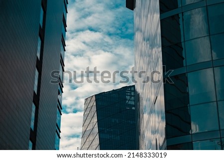Modern architecture or business background photo. Skyscrapers with cloudy sky.