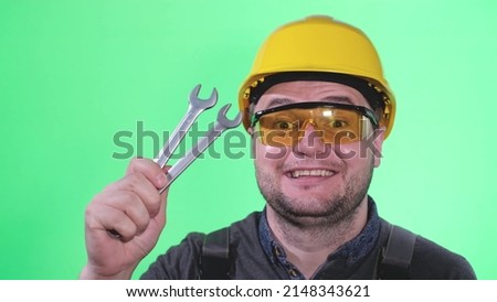 Engineer on a background of chromakey, Portrait of a car mechanic on a green background
