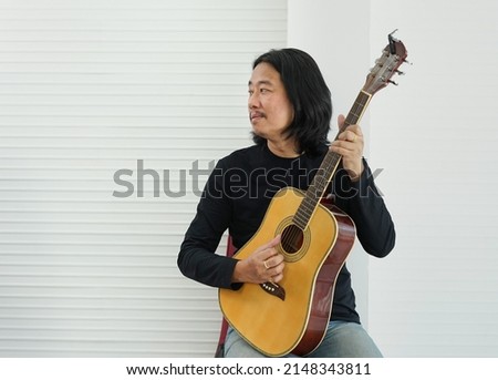 guitarist male hold guitar sitting on chair,acoustic music musician concept                               