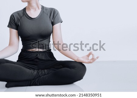 Head cropped woman, sitting in yoga position and meditating isolated over white background. Copy space for healthy lifestyle concept. 