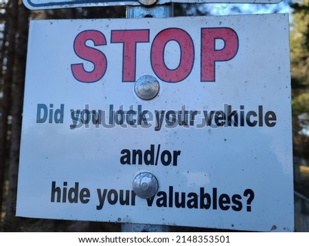 A sign reminding you to lock your vehicle and hide your valuables. It says "Stop Did you lock your vehicle and or hide your valuables?".