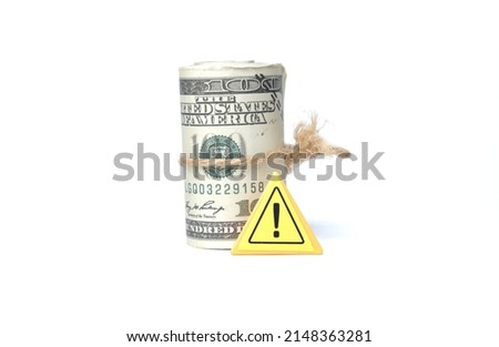 A picture of fake money with warning sign on white background. Financial crime concept.