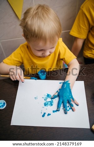 Hands of painting little boy and the table for creativity.hand kids painting. High quality photo